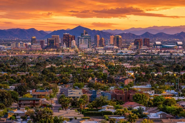 Phoenix, Arizona skyline at sunset with mountains and residential neighborhoods