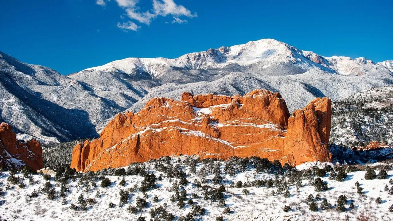 Garden of the Gods red rock formations with a snow-capped Pikes Peak behind them near Colorado Springs, Colorado