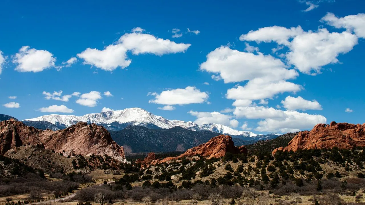 Garden of the Gods red rock formations near Colorado Springs, Colorado, with snow-capped mountains behind