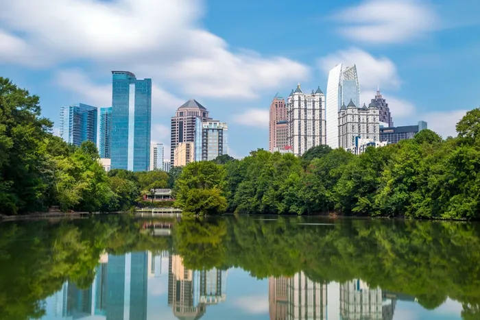 The Midtown Atlanta, Georgia skyline reflected in the lake at Piedmont Park