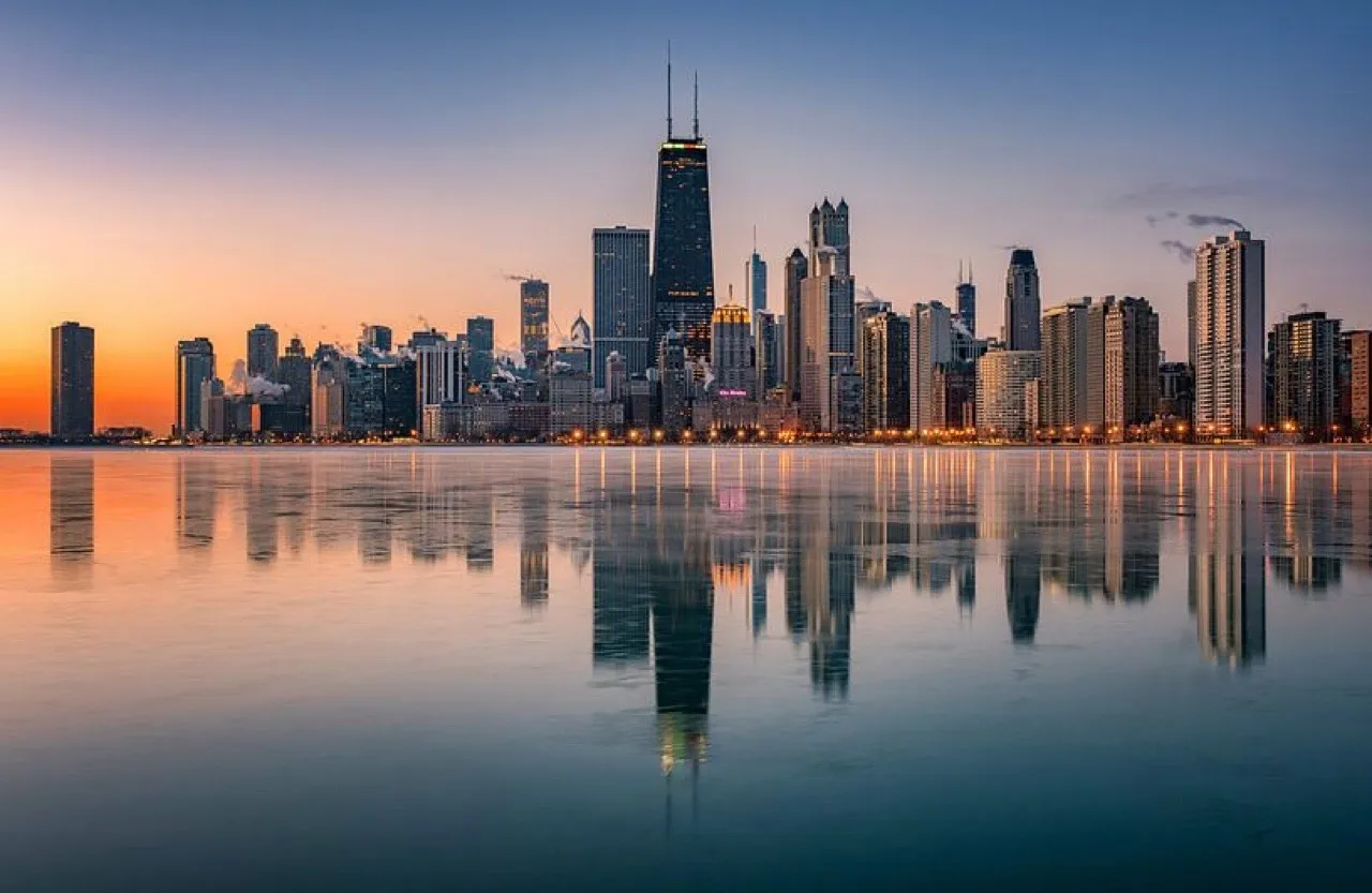 The Chicago, Illinois skyline at sunset reflected over Lake Michigan