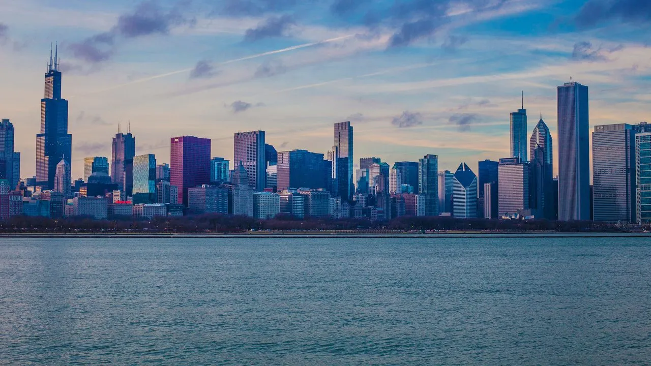 The Chicago, Illinois skyline across Lake Michigan at dusk