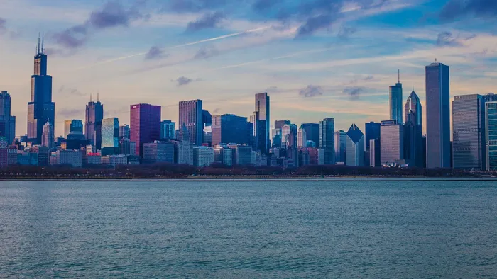 The Chicago, Illinois skyline across Lake Michigan at dusk