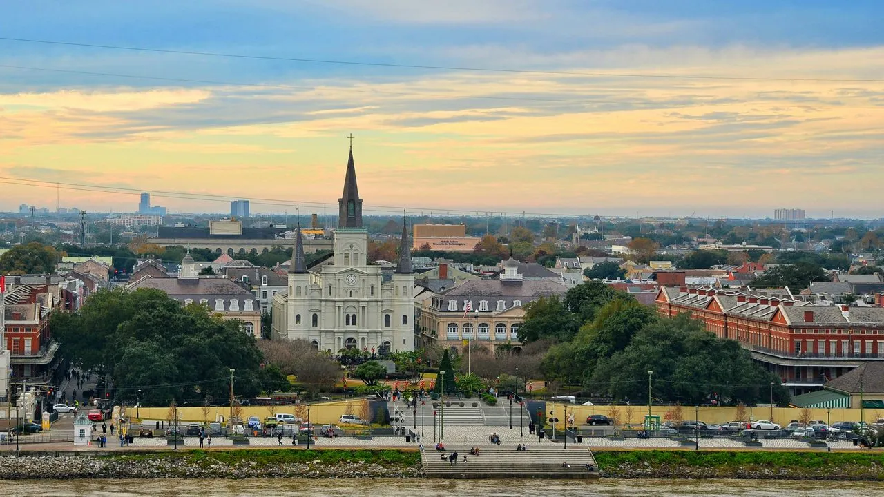 St. Louis Cathedral and Jackson Square in the French Quarter of New Orleans, Louisiana, seen across the Mississippi River at golden hour