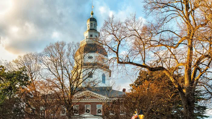 The Maryland State House dome rising above bare winter trees in Annapolis, Maryland