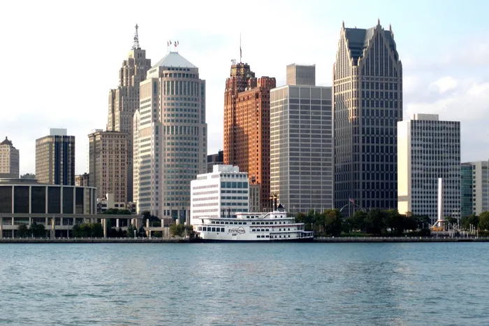 Downtown Detroit, Michigan skyline over the Detroit River with the Detroit Princess riverboat