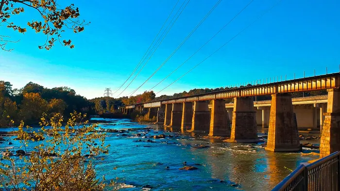 A historic bridge over the river at Riverfront Park in Columbia, South Carolina, in late-afternoon sun