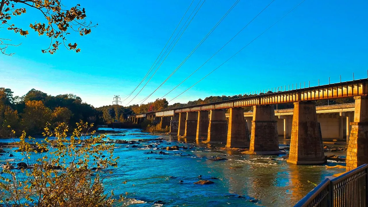 A historic bridge over the river at Riverfront Park in Columbia, South Carolina, in late-afternoon sun