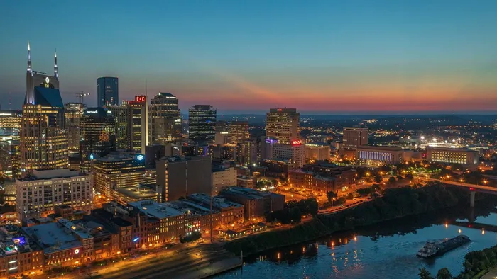 The Nashville, Tennessee skyline lit at dusk above the Cumberland River
